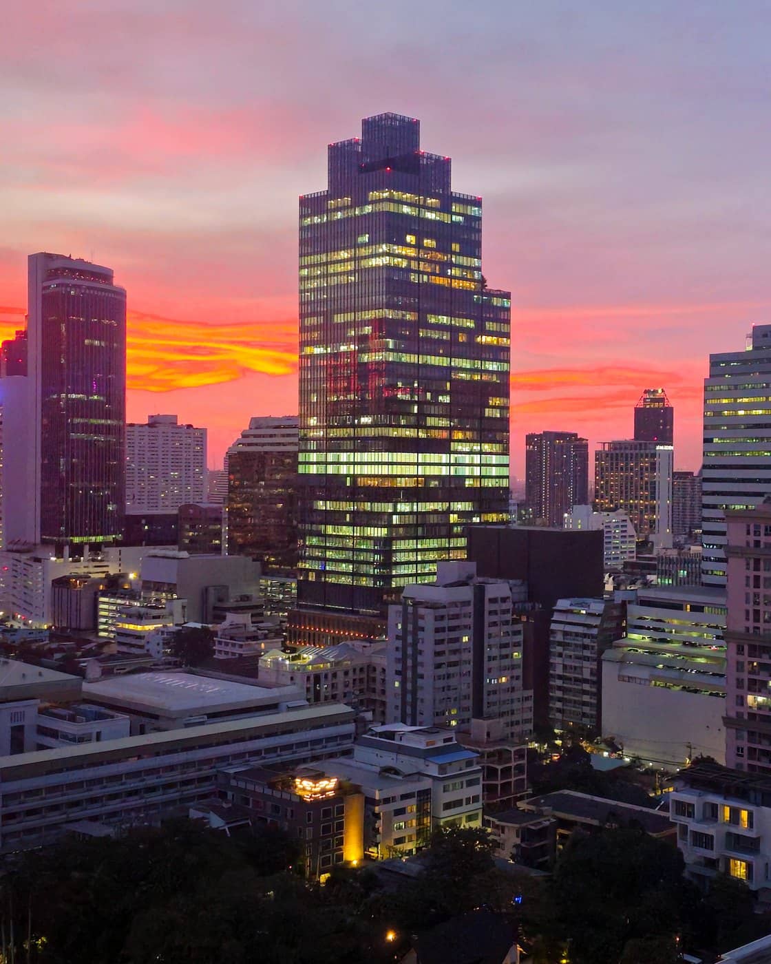 Office towers in Bangkok's Silom district at sunset.